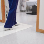 nurse walking on cleanroom mat